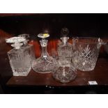 Four decanters, a glass punch bowl with twelve cups and ladle, a crystal ice bucket and a water jug