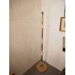 An onyx and brass standard lamp, on circular base, 53 1/2" high