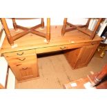 A pine double pedestal desk, fitted four drawers, keyboard drawer and cupboard, 60" wide x 26"