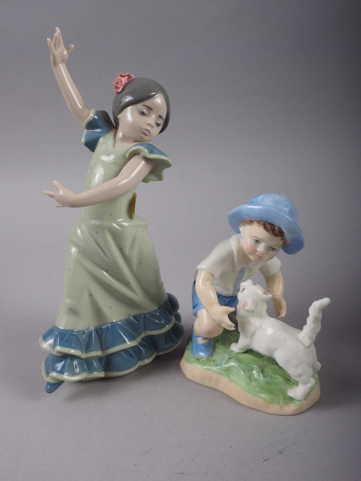 A Lladro china figure of a Spanish dancer, 7 1/2" high, and a Royal Worcester Doughty figure "