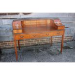 A Sheraton Revival satinwood and line inlaid Carlton House desk with galleried top, painted urn,