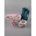 A Continental porcelain pink floral decorated tazza, a blue glazed vase moulded parrots and a