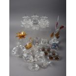 A collection of Swarovski crystal, including a triple pricket candlestick, a gilt metal mounted