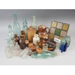 A quantity of glass bottles, including a codd bottle, a poison bottle, a Doulton hunting jug (