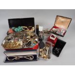 A quantity of costume jewellery, including gold coloured chains, coins, beaded necklaces, a pair