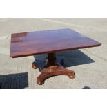 An early 19th century mahogany rectangular topped breakfast table, on turned and faceted column