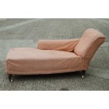 A late 19th century walnut frame chaise longue, upholstered in a leaf figured brocade with pink