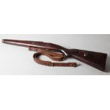A hardwood rifle stock, 29 3/4" long overall, with spare leather strap