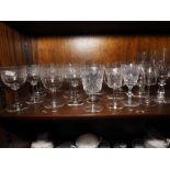 Eight etched pedestal glasses and other drinking glasses