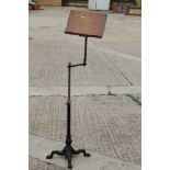 A 19th century Carters Patent oak brass and cast iron adjustable book stand, on splay support