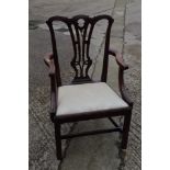 A George III carved mahogany carver chair with pierced splat back and drop-in seat, on chamfered
