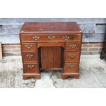 A late Georgian mahogany kneehole desk, fitted one long drawer over central recess and six
