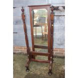 A 1930s oak framed cheval mirror, 74" high