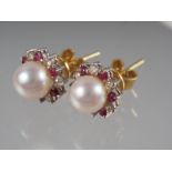 A pair of 18ct pearl, ruby and diamond collar ear studs, pearl 6.7mm dia approx