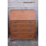 A mahogany and box line inlaid fall front bureau with fitted writing compartment over four long