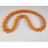 A graduated "amber" bead necklace, 24" long approx