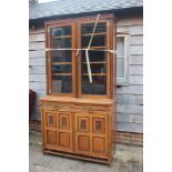 A 19th century walnut and ebonised bookcase with glazed upper section enclosed two doors over two