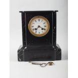 A black marble and slate mantel clock, by W H Skinner and F White, with white enamel dial and