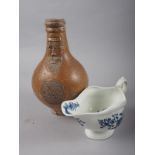 A 17th century stoneware "Bellarmine", 8 1/2" high (no handle) and an early Worcester sauce boat, 7"