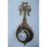A French gilt and black metal wall clock with ribbon finial, white enamel dial, Roman and Arabic