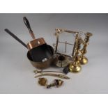 A 19th century copper scoop with turned wood handle, a brass saucepan, a pair of candlesticks, a