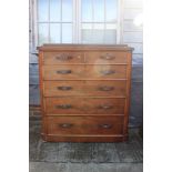 A 19th century figured mahogany chest of two short and four long graduated drawers with carved