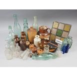 A quantity of glass bottles, including a Codd bottle, a poison bottle, a Doulton hunting jug (