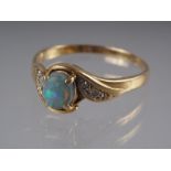 A yellow metal ring, stamped K 18, set black opal doublet and rose diamond shoulders, size O 1/2, 3g