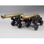 A pair of brass and cast iron model cannons, 9 3/4" high x 17" long
