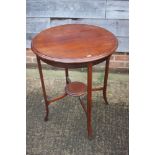 A mahogany low oval occasional table, 48" wide x 27" deep x 21" high, and a mahogany circular