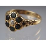 An 18ct gold and tourmaline cluster set dress ring with central diamond, 3.6 gross, size M (