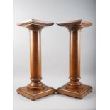 A pair of oak stands, on turned columns and square bases, 10 1/4" square x 27" high