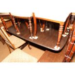A G-Plan "dark oak" extending dining table, on twin turned supports