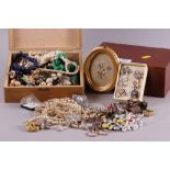 An assortment of costume jewellery, including beaded necklaces, rings, pendants, an oval-shaped box,