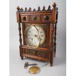 A late 19th century oak and brass mounted "Gothic" mantel clock with eight-day striking movement and