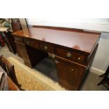 A William IV figured mahogany double pedestal sideboard, fitted three drawers with ring handles over