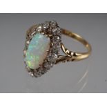 An 18ct yellow gold dress ring, set oval opal with collar of diamonds, opal 13mm x 6mm approx,