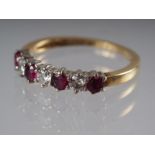 An 18ct gold half-eternity hoop set rubies, .52ct approx, and diamonds .26ct approx, size M/N