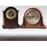 A mahogany cased mantel clock with white enamel dial and Roman numerals, flanked by two brass
