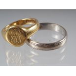 An 18ct gold signet ring, size 'J', 5.3g, and an 18ct gold and white gold wedding band, 3.7g