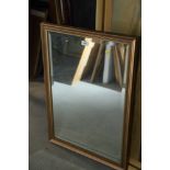 A rectangular wall mirror with bevelled plate, 28" x 19", in gilt frame