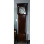 An Edwardian mahogany longcase clock with striking and chiming movement and silvered dial, 73" high