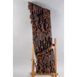A Far Eastern carved hardwood panel, animals and figures in a landscape, 32" high