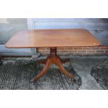 A 19th century mahogany rectangular tilt top breakfast table, on tuned column and quadruple splay