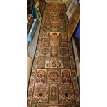 A Persian garden style runner in shades of blue, brown, fawn, green and natural, 134" x 27" approx