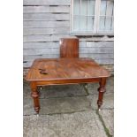 A mid 19th century mahogany extending dining table with two extra leaves, on turned and castored