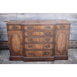 A walnut and banded breakfront sideboard, fitted two cupboards and central drawers, the top two