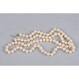 A cultured pearl necklace with silver and pearl clasp, 32" long