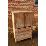 A 1930s limed oak linen cupboard enclosed two doors over three drawers, 30" wide x 18 1/2" deep x