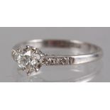 A platinum and diamond dress ring, the central stone flanked three small diamonds to each